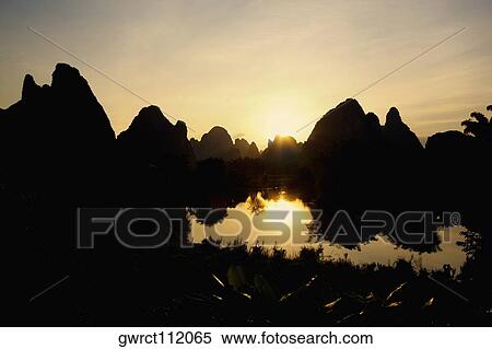Stock Photography - Silhouette of hill ranges at dusk, Guilin Hills, Xingping, Yangshuo, Guangxi Province, China. Fotosearch