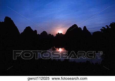 Silhouette of hills at dusk, Guilin Hills, Li River, Yangshuo, Guangxi Province, China View Large Photo Image Stock Photography - Silhouette of hills at dusk, Guilin Hills, Li River, Yangshuo, Guangxi Province, China. Fotosearch