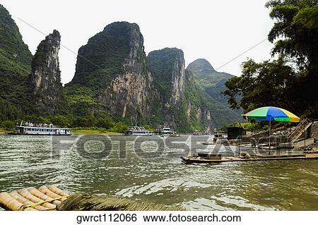 Tourboats in a river, XingPing, Yangshuo, Guangxi Province, China View Large Photo Image Stock Photograph - Tourboats in a river, XingPing, Yangshuo, Guangxi Province, China. Fotosearch