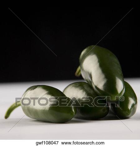 Close-up of four green chili peppers View Large Photo Image Stock Photo - Close-up of four green chili peppers. Fotosearch