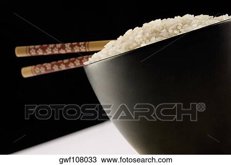 Close-up of white rice and chopsticks in a bowl View Large Photo Image Stock Image - Close-up of white rice and chopsticks in a bowl. Fotosearch