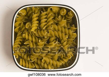 High angle view of bowl of raw fusilli pasta View Large Photo Image Stock Photograph - High angle view of bowl of raw fusilli pasta. Fotosearch