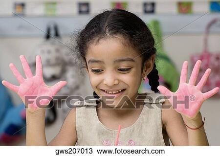 Close-up of a girl showing paint covered hands and smiling View Large Photo Image Stock Image - Close-up of a girl showing paint covered hands and smiling. Fotosearch