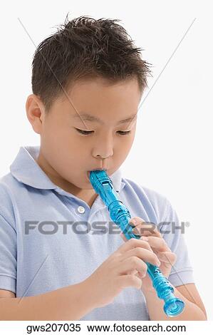 Close-up of a schoolboy playing a flute View Large Photo Image Stock Photography - Close-up of a schoolboy playing a flute. Fotosearch