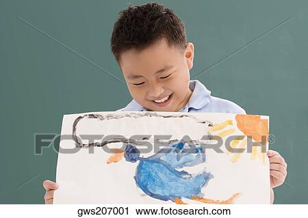 Close-up of a schoolboy showing his drawing and smiling View Large Photo Image Stock Image - Close-up of a schoolboy showing his drawing and smiling. Fotosearch