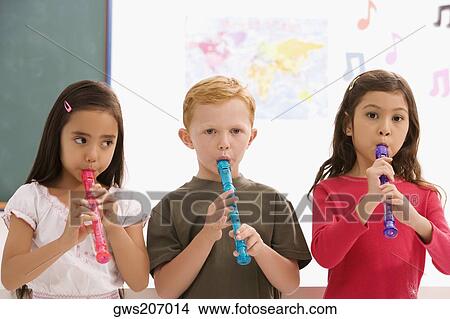 Picture - Close-up of a schoolboy with two schoolgirls playing flutes. Fotosearch