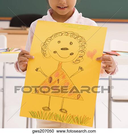 Close-up of a schoolgirl showing her drawing and smiling View Large Photo Image Stock Image - Close-up of a schoolgirl showing her drawing and smiling. Fotosearch