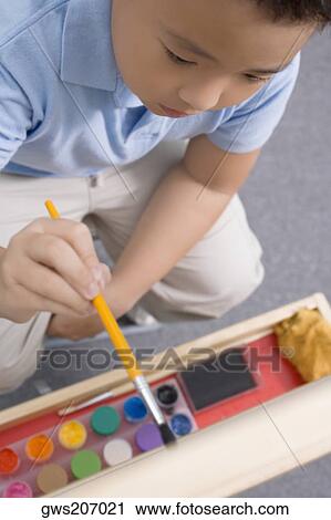 High angle view of a schoolboy painting in an art class View Large Photo Image Stock Image - High angle view of a schoolboy painting in an art class. Fotosearch