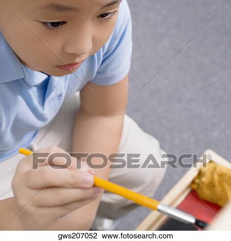 High angle view of a schoolboy painting in an art class View Large Photo Image Stock Image - High angle view of a schoolboy painting in an art class. Fotosearch