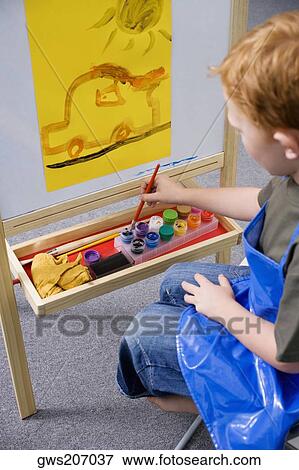 High angle view of a schoolboy painting in an art class View Large Photo Image Stock Photo - High angle view of a schoolboy painting in an art class. Fotosearch