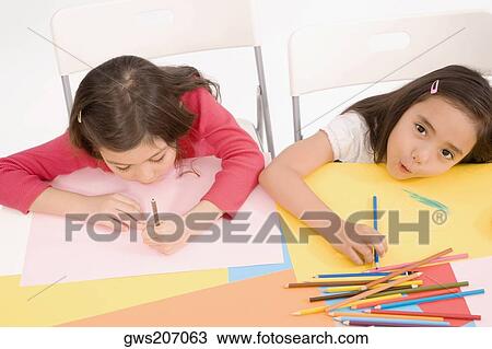 High angle view of two schoolgirls drawing in an art class View Large Photo Image Stock Image - High angle view of two schoolgirls drawing in an art class. Fotosearch