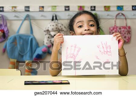Portrait of a girl showing a drawing View Large Photo Image Picture - Portrait of a girl showing a drawing. Fotosearch