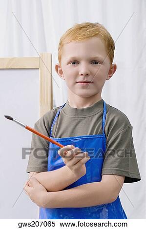Portrait of a schoolboy holding a paintbrush and smiling View Large Photo Image Stock Photography - Portrait of a schoolboy holding a paintbrush and smiling. Fotosearch