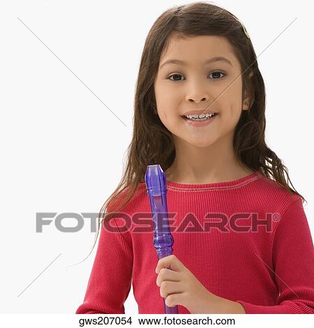 Portrait of a schoolgirl holding a flute and smiling View Large Photo Image Picture - Portrait of a schoolgirl holding a flute and smiling. Fotosearch