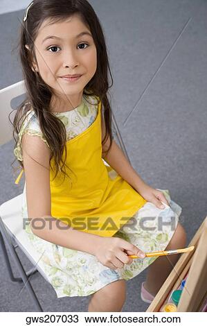 Portrait of a schoolgirl painting in an art class View Large Photo Image Stock Image - Portrait of a schoolgirl painting in an art class. Fotosearch