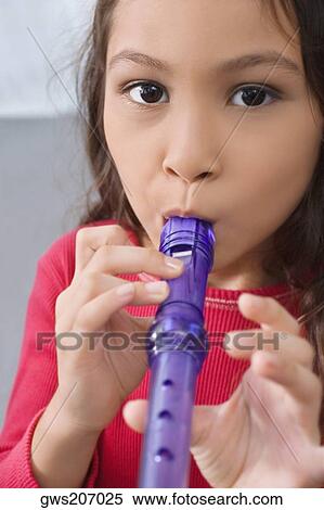 Portrait of a schoolgirl playing a flute View Large Photo Image Stock Photography - Portrait of a schoolgirl playing a flute. Fotosearch