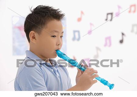Side profile of a schoolboy playing a flute View Large Photo Image Stock Image - Side profile of a schoolboy playing a flute. Fotosearch