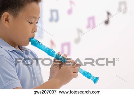 Side profile of a schoolboy playing a flute View Large Photo Image Stock Photo - Side profile of a schoolboy playing a flute. Fotosearch