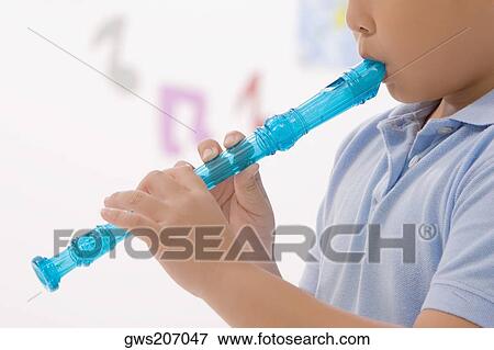Side profile of a schoolboy playing a flute View Large Photo Image Stock Photo - Side profile of a schoolboy playing a flute. Fotosearch