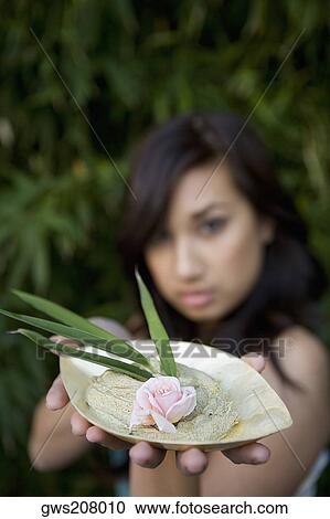 Close-up of a young woman holding a bowl of herb View Large Photo Image Stock Image - Close-up of a young woman holding a bowl of herb. Fotosearch