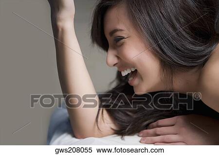 Close-up of a young woman lying on a massage table and laughing View Large Photo Image Stock Photography - Close-up of a young woman lying on a massage table and laughing. Fotosearch
