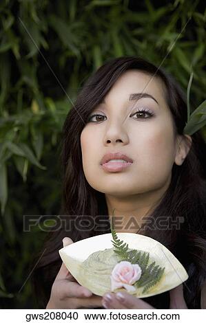 Portrait of a young woman holding a bowl View Large Photo Image Stock Image - Portrait of a young woman holding a bowl. Fotosearch