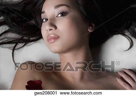 Portrait of a young woman lying on a massage table View Large Photo Image Stock Image - Portrait of a young woman lying on a massage table. Fotosearch