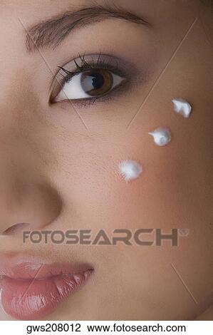Portrait of a young woman with cream on her cheek View Large Photo Image Stock Image - Portrait of a young woman with cream on her cheek. Fotosearch