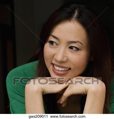 Close-up of a young woman smiling View Large Photo Image Stock Image - Close-up of a young woman smiling. Fotosearch