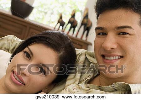 Portrait of a young couple smiling View Large Photo Image Stock Photo - Portrait of a young couple smiling. Fotosearch