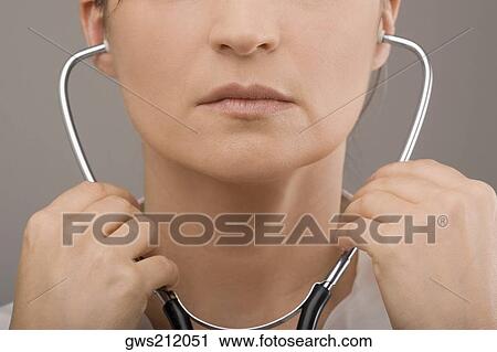 Stock Image - Close-up of a female doctor wearing a stethoscope. Fotosearch