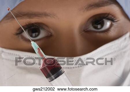 Close-up of a female doctor with a syringe View Large Photo Image Stock Image - Close-up of a female doctor with a syringe. Fotosearch
