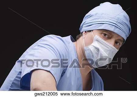 Close-up of a male surgeon wearing scrubs and a surgical mask View Large Photo Image Stock Photography - Close-up of a male surgeon wearing scrubs and a surgical mask. Fotosearch