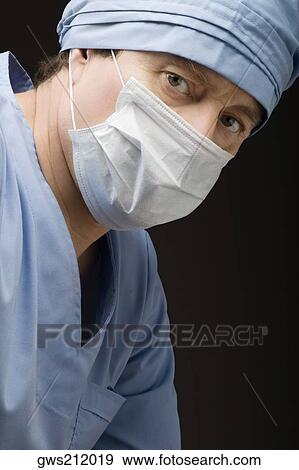 Stock Photo - Close-up of a surgeon wearing scrubs and a surgical mask. Fotosearch