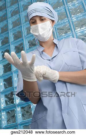 Female surgeon wearing surgical gloves View Large Photo Image Stock Photo - Female surgeon wearing surgical gloves. Fotosearch