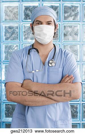 Male surgeon wearing a surgical mask View Large Photo Image Stock Image - Male surgeon wearing a surgical mask. Fotosearch