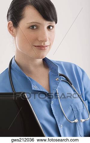 Stock Photograph - Portrait of a female surgeon with a file and stethoscope. Fotosearch