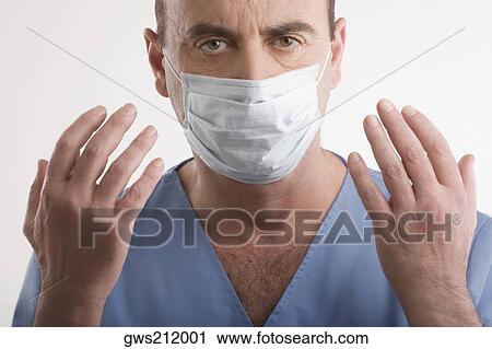 Portrait of a male surgeon with his arms raised View Large Photo Image Stock Image - Portrait of a male surgeon with his arms raised. Fotosearch