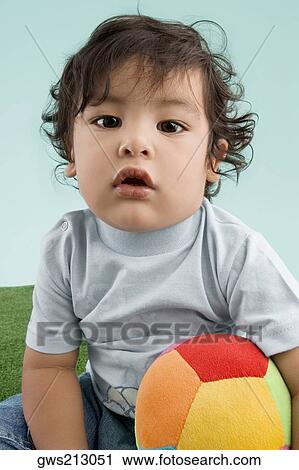 Portrait of a boy playing with a ball View Large Photo Image Stock Image - Portrait of a boy playing with a ball. Fotosearch