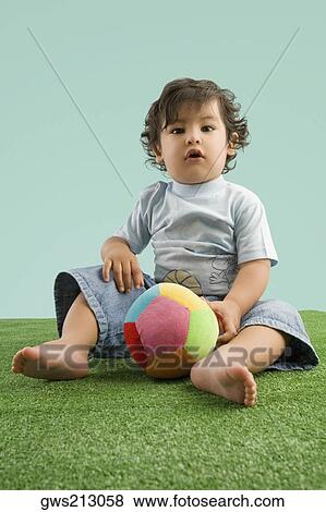Portrait of a boy playing with a ball View Large Photo Image Stock Photo - Portrait of a boy playing with a ball. Fotosearch