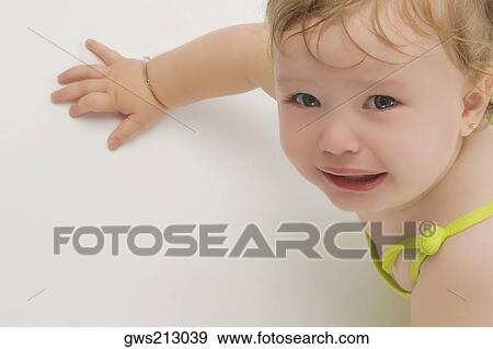 Stock Photo - Portrait of a girl crying. Fotosearch