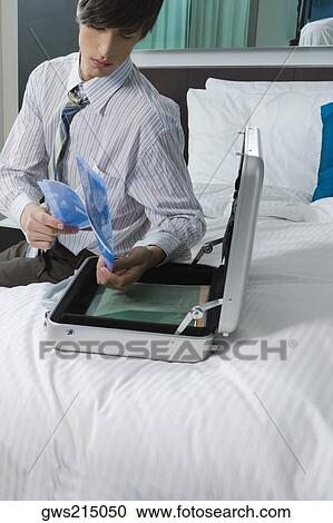 Businessman checking transparent papers View Large Photo Image Stock Image - Businessman checking transparent papers. Fotosearch