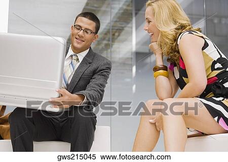 Businessman holding a briefcase with a mature woman sitting beside him View Large Photo Image Stock Photography - Businessman holding a briefcase with a mature woman sitting beside him. Fotosearch