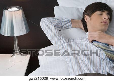 Businessman sleeping on the bed View Large Photo Image Stock Photo - Businessman sleeping on the bed. Fotosearch