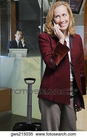 Mature woman talking on a mobile phone and smiling View Large Photo Image Stock Photography - Mature woman talking on a mobile phone and smiling. Fotosearch