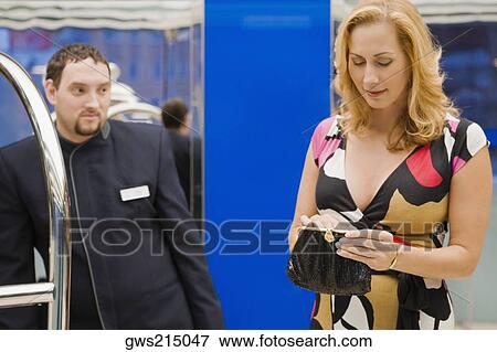 Mature woman tipping a waiter View Large Photo Image Stock Photo - Mature woman tipping a waiter. Fotosearch