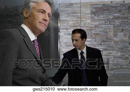 Side profile of a mature man standing at the reception View Large Photo Image Stock Image - Side profile of a mature man standing at the reception. Fotosearch
