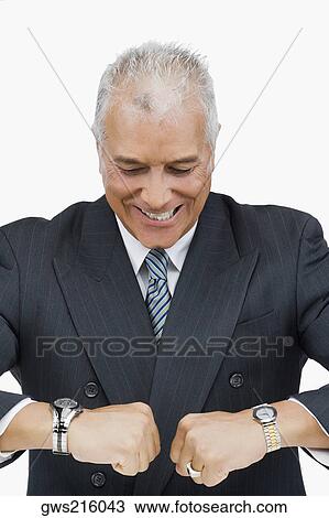Close-up of a businessman looking at his wristwatches View Large Photo Image Stock Image - Close-up of a businessman looking at his wristwatches. Fotosearch
