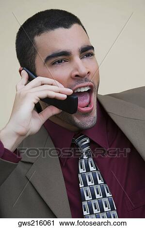 Close-up of a businessman talking on a mobile phone View Large Photo Image Stock Image - Close-up of a businessman talking on a mobile phone. Fotosearch