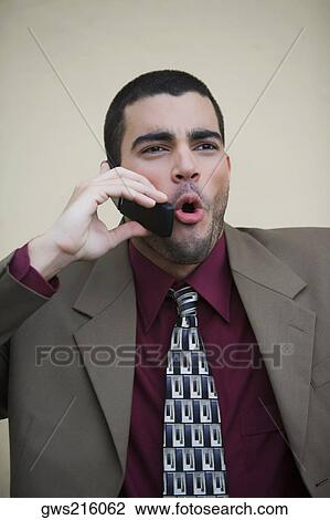 Stock Image - Close-up of a businessman talking on a mobile phone. Fotosearch